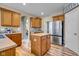Spacious kitchen with stainless steel appliances, wooden cabinets, and wood plank flooring at 7714 Black Walnut Dr, Avon, IN 46123