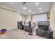 Carpeted basement theater room with projector and comfortable reclining seating at 7714 Black Walnut Dr, Avon, IN 46123