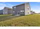 Exterior view of home showcasing siding, windows, a well-maintained lawn, and backyard at 8546 Strabet Dr, Pendleton, IN 46064