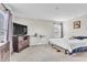 This bedroom has neutral walls, carpet, and a wooden dresser topped with a TV at 8546 Strabet Dr, Pendleton, IN 46064