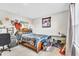 Comfortable bedroom featuring neutral walls, carpeted floor, and a bed with assorted posters and decorations at 8546 Strabet Dr, Pendleton, IN 46064