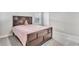 A bedroom with a dark wood bed frame and a window that offers plenty of natural light at 8546 Strabet Dr, Pendleton, IN 46064