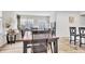 Open-concept dining room with a large table, chairs, and views into the cozy living area at 8546 Strabet Dr, Pendleton, IN 46064