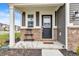 Inviting front porch featuring a black front door, brick accents, and space for decor at 8546 Strabet Dr, Pendleton, IN 46064
