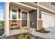 Inviting front porch features a decorative plant stand, creating a warm welcome to the home at 8546 Strabet Dr, Pendleton, IN 46064