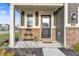 Welcoming front porch features a decorative plant stand and a charming entrance at 8546 Strabet Dr, Pendleton, IN 46064