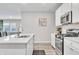 Modern kitchen featuring white cabinets, stainless steel appliances, and a quartz countertop at 8546 Strabet Dr, Pendleton, IN 46064