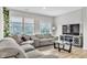 Bright living room with a plush sectional sofa, large windows, and a modern entertainment center at 8546 Strabet Dr, Pendleton, IN 46064