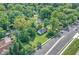 Aerial view shows a property, surrounded by trees, with a street nearby at 8553 Broadway St, Indianapolis, IN 46240