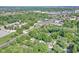 An aerial view shows a property surrounded by lush trees, adjacent to a street at 8553 Broadway St, Indianapolis, IN 46240