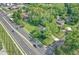 An aerial view of a property surrounded by trees, with a street nearby at 8553 Broadway St, Indianapolis, IN 46240