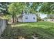 Large backyard with grass and a view of the back of the house at 8553 Broadway St, Indianapolis, IN 46240