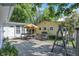 Backyard patio with seating area, yellow-colored house, and swing set at 8553 Broadway St, Indianapolis, IN 46240