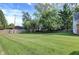 Large backyard with a high wooden fence on one side at 8553 Broadway St, Indianapolis, IN 46240