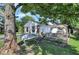 Backyard featuring a hammock and patio set, partially shaded by a tree at 8553 Broadway St, Indianapolis, IN 46240