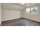 Cozy bedroom with new vinyl floors and natural light from a large window at 8553 Broadway St, Indianapolis, IN 46240