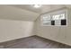 Bedroom with light-colored walls, window and gray wood laminate flooring at 8553 Broadway St, Indianapolis, IN 46240