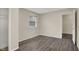 This bedroom features neutral walls, wood floors, and a window with blinds at 8553 Broadway St, Indianapolis, IN 46240
