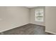 This bedroom features neutral walls, wood floors, and a window with blinds at 8553 Broadway St, Indianapolis, IN 46240