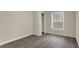 Cozy bedroom with vinyl flooring, neutral walls, and a window overlooking the outdoors at 8553 Broadway St, Indianapolis, IN 46240