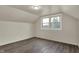 Sunny bedroom featuring new vinyl floors and large window overlooking the neighborhood at 8553 Broadway St, Indianapolis, IN 46240