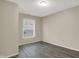 Simple bedroom with neutral walls, wood-look flooring, and a bright window at 8553 Broadway St, Indianapolis, IN 46240