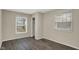 This bedroom features neutral walls, wood floors, and a window with blinds and closet at 8553 Broadway St, Indianapolis, IN 46240
