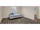 This bedroom features neutral walls, wood floors, and a window with blinds at 8553 Broadway St, Indianapolis, IN 46240