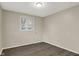 Bedroom featuring new vinyl flooring, neutral paint, and window at 8553 Broadway St, Indianapolis, IN 46240