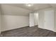 Bedroom featuring new vinyl flooring, white trim and neutral paint with multiple doors at 8553 Broadway St, Indianapolis, IN 46240