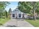 Charming house showcasing a brick and white wood exterior with a concrete driveway at 8553 Broadway St, Indianapolis, IN 46240