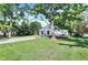 A long concrete driveway leading to a cozy home nestled among mature trees and green lawns at 8553 Broadway St, Indianapolis, IN 46240
