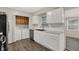 Bright kitchen featuring white cabinets, modern appliances, and a convenient laundry area at 8553 Broadway St, Indianapolis, IN 46240