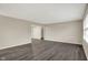 Spacious living area with gray wood flooring, neutral paint, and access to a walk-in closet at 8553 Broadway St, Indianapolis, IN 46240