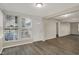 Welcoming living room featuring large windows, a front door, and wood-look flooring at 8553 Broadway St, Indianapolis, IN 46240
