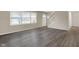 Spacious living room with new gray wood flooring, bright windows, and a staircase at 8553 Broadway St, Indianapolis, IN 46240