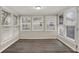 Bright sunroom with multiple windows providing ample natural light and vinyl flooring at 8553 Broadway St, Indianapolis, IN 46240