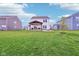 Spacious backyard with a covered patio, a fire pit, ample green space, and pond views at 8663 Kellner St, Pendleton, IN 46064