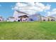 Spacious backyard with a covered patio, seating area, and fire pit, perfect for outdoor entertaining at 8663 Kellner St, Pendleton, IN 46064