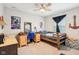 Comfortable bedroom featuring a ceiling fan, wooden bed frame, and desk with unique decor and accents at 8663 Kellner St, Pendleton, IN 46064