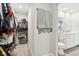 Walk-in closet with abundant shelving and hanging space adjacent to bathroom; towels on rack at 8663 Kellner St, Pendleton, IN 46064