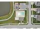 Aerial view of community with a pool, playground, parking and green spaces, and a serene pond at 8663 Kellner St, Pendleton, IN 46064