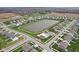 Community aerial showcasing the large pond, community pool, playground and surrounding homes at 8663 Kellner St, Pendleton, IN 46064