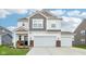 Two-story home featuring a 2-car garage, landscaped front yard, and a welcoming porch at 8663 Kellner St, Pendleton, IN 46064
