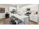 Modern kitchen with stainless steel appliances, an island, and sleek white cabinetry at 8663 Kellner St, Pendleton, IN 46064