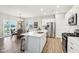 Modern kitchen features a spacious island with a stainless steel refrigerator and sleek countertops at 8663 Kellner St, Pendleton, IN 46064