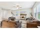 Comfortable living room features neutral walls, ceiling fan, a large wall-mounted television, and wood-look flooring at 8663 Kellner St, Pendleton, IN 46064