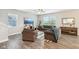 Spacious living room with natural light, wood-look floors, gray sofas, ceiling fan, and modern decor at 8663 Kellner St, Pendleton, IN 46064