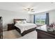 Comfortable main bedroom with a ceiling fan, a large window, and a stylish dark wood bedroom set at 8663 Kellner St, Pendleton, IN 46064