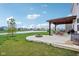 Beautiful backyard patio with a pergola, an outdoor kitchen, a pond view, and a firepit at 8663 Kellner St, Pendleton, IN 46064